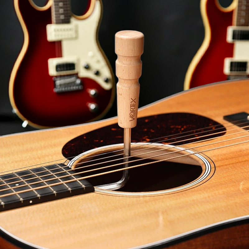 clé de réglage de manche de guitare dans studio de musique avec une guitare derriére 